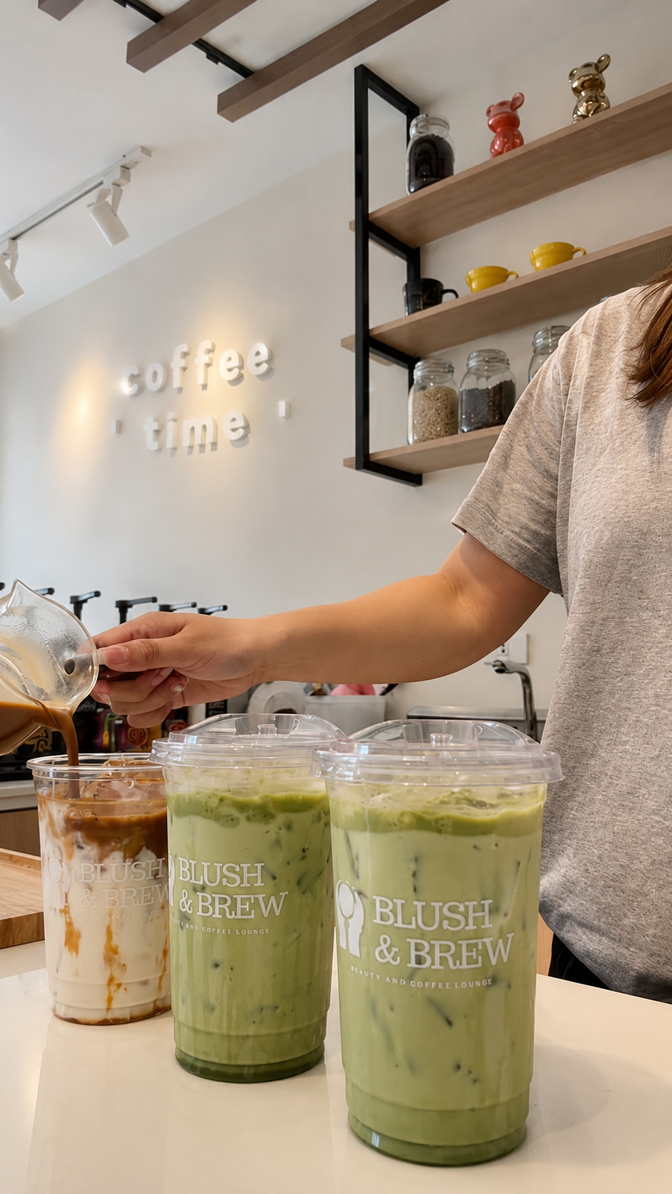 A drink being poured beside iced matcha drinks at the Blush & Brew counter.